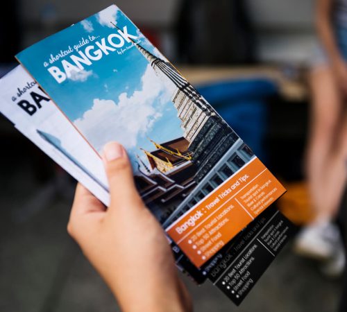 closeup-of-hand-holding-bangkok-travel-guide-broch-2022-12-15-22-54-36-utc