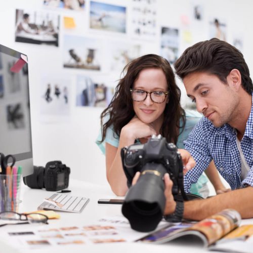 two-young-photographers-looking-at-photos-on-a-dig-2022-09-30-22-18-06-utc